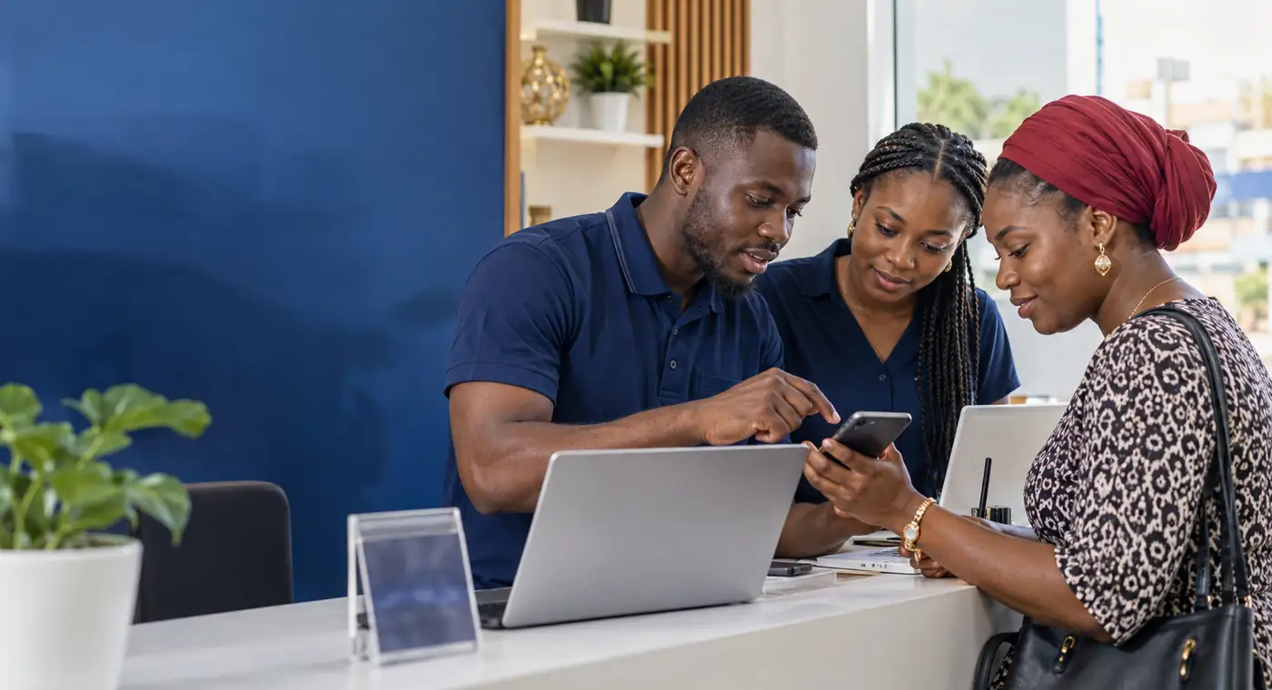 A Ghanaian digital team helping a customer complete a mobile purchase